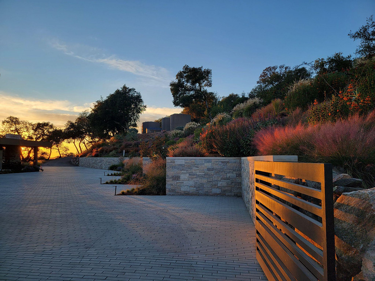 paved driveway with brick walls against the mountainside