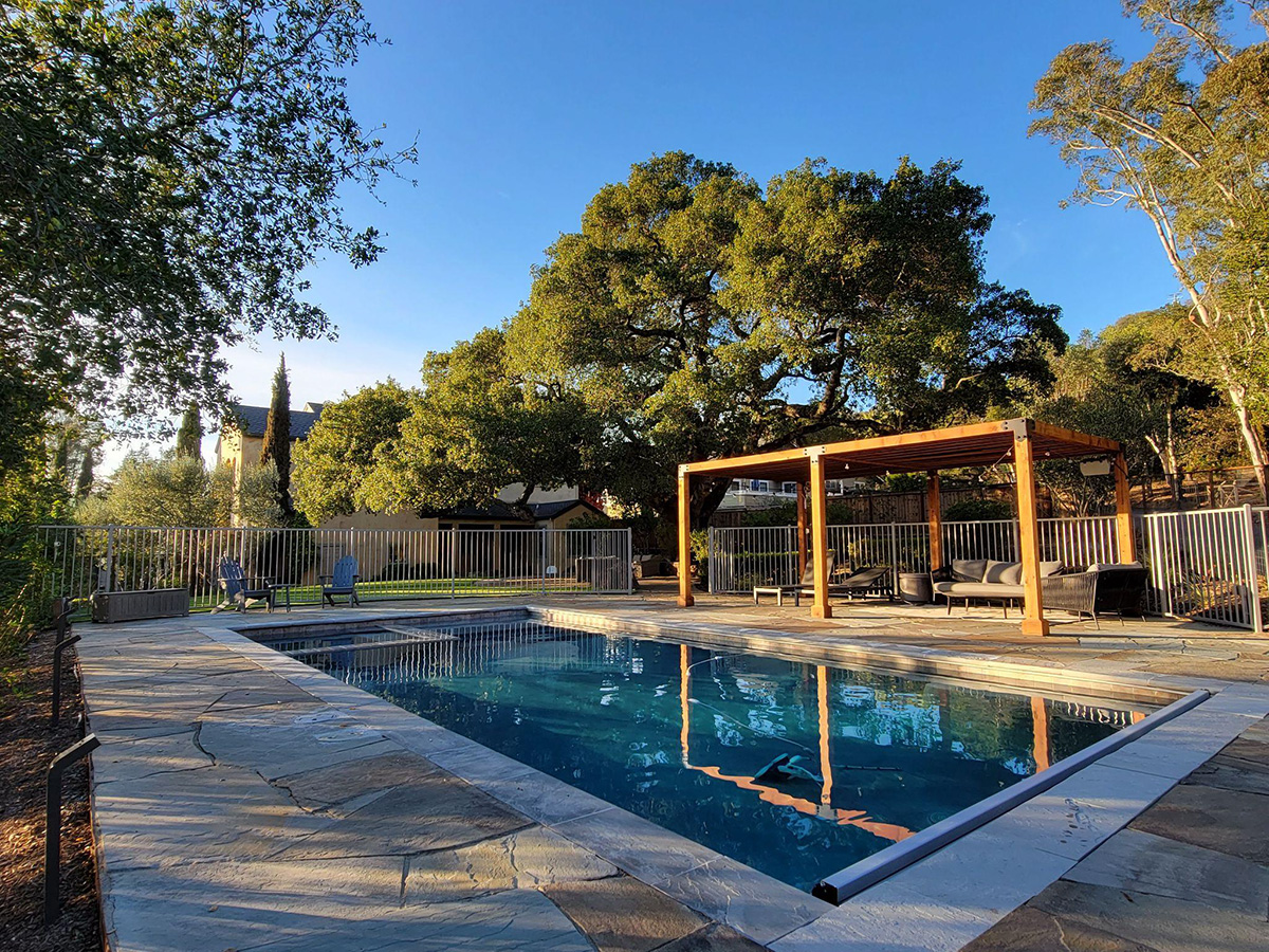 Large pool surrounded by trees and seating