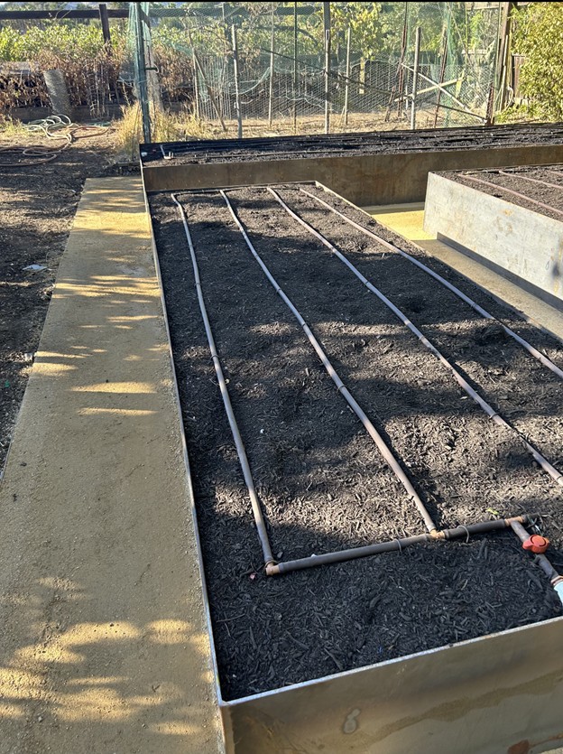 Surface run in-line emitter drip tubing for a vegetable garden