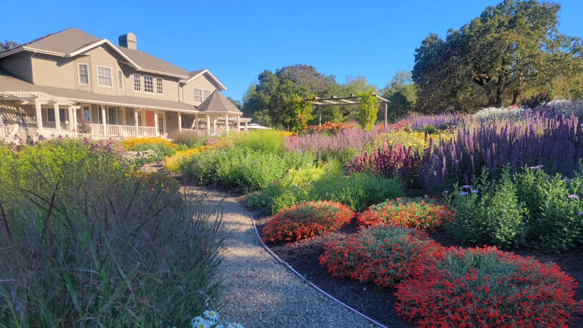 A lush and colorful landscape surrounds a large home in Sonoma County.