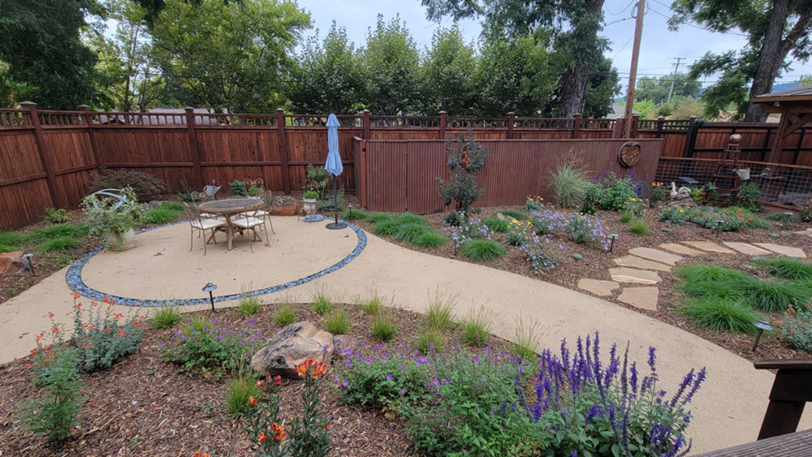 A backyard landscaped with multiple different kinds of hardscaping materials.
