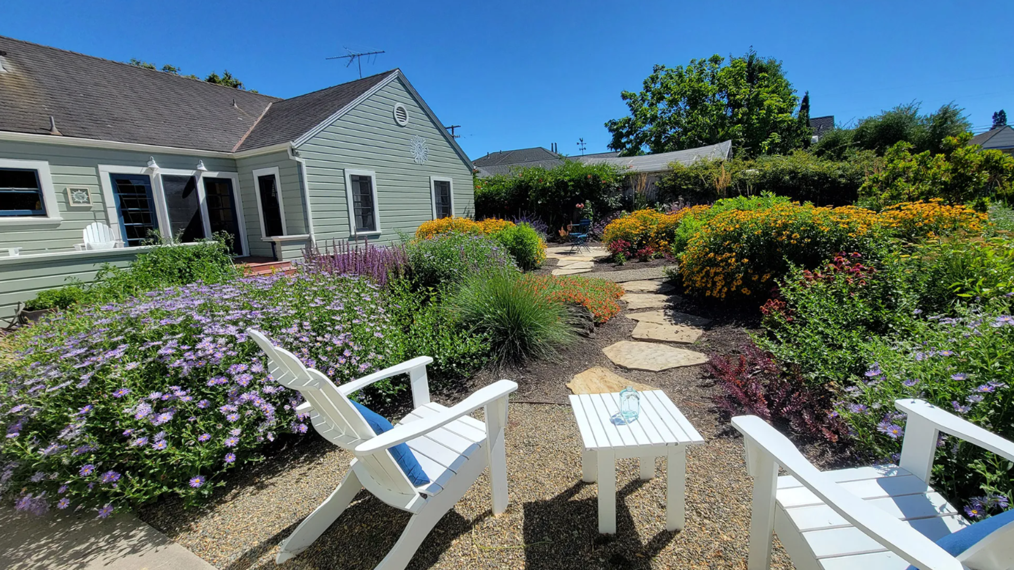 An outdoor lounging area in the middle of a pollinator paradise landscape in Petaluma.
